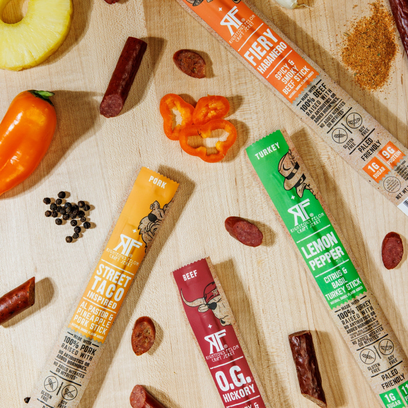 RF meat sticks on wooden background with ingredients