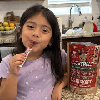 Kid enjoying a Lil' Rebels mini stick